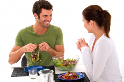 couple eating salad and smiling