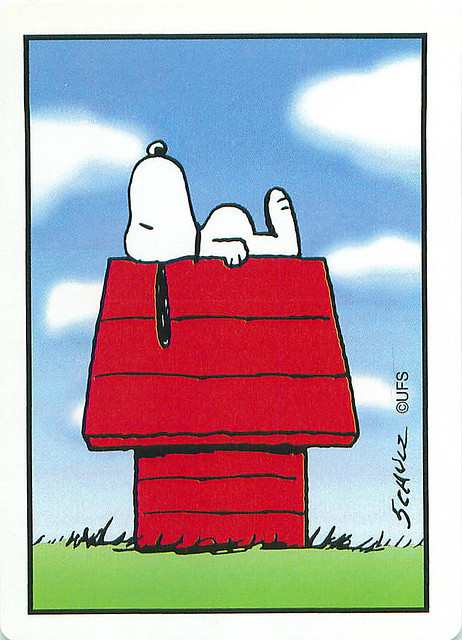 snoopy on top his house, laying flat depressed look