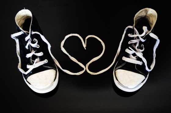 tennis shoes black and white with heart in between